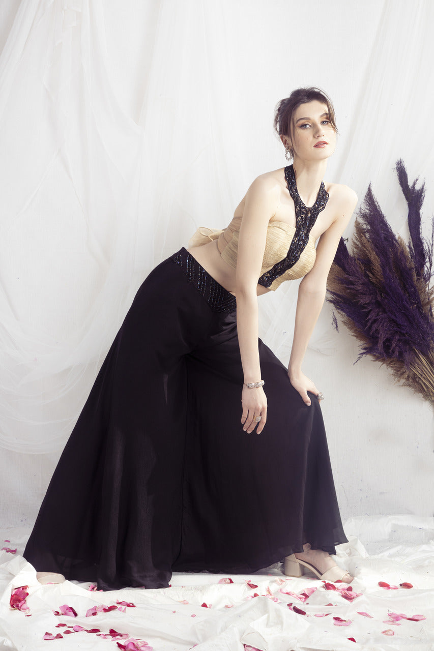 Beige halter neck blouse and black flared pants set