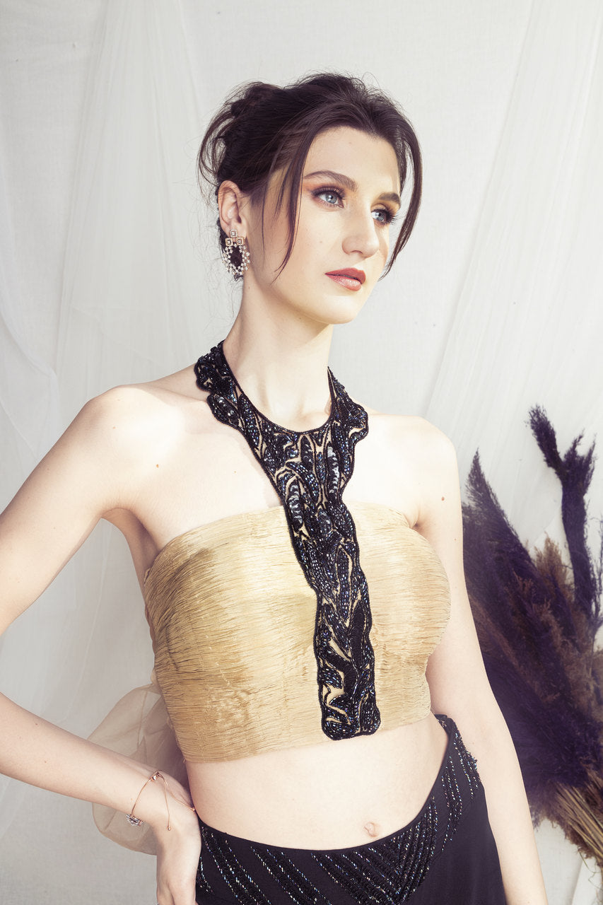 Beige halter neck blouse and black flared pants set